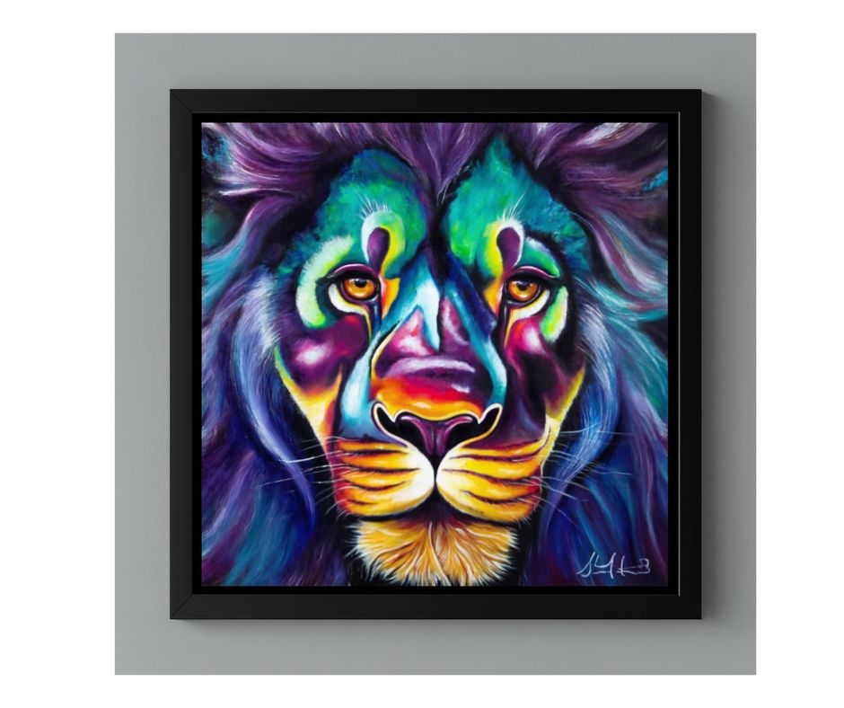 A close-up, framed painting of a lion's head, titled 'The Many Colors of Love.' The lion's fur and face are rendered in intensely bright, unnatural colors, primarily deep purple, vibrant teal, bright green, and yellow on the nose and chin, giving the portrait a psychedelic or electric appearance. The lion has bright yellow/orange eyes and the painting is contained within a black frame, set against a plain gray background