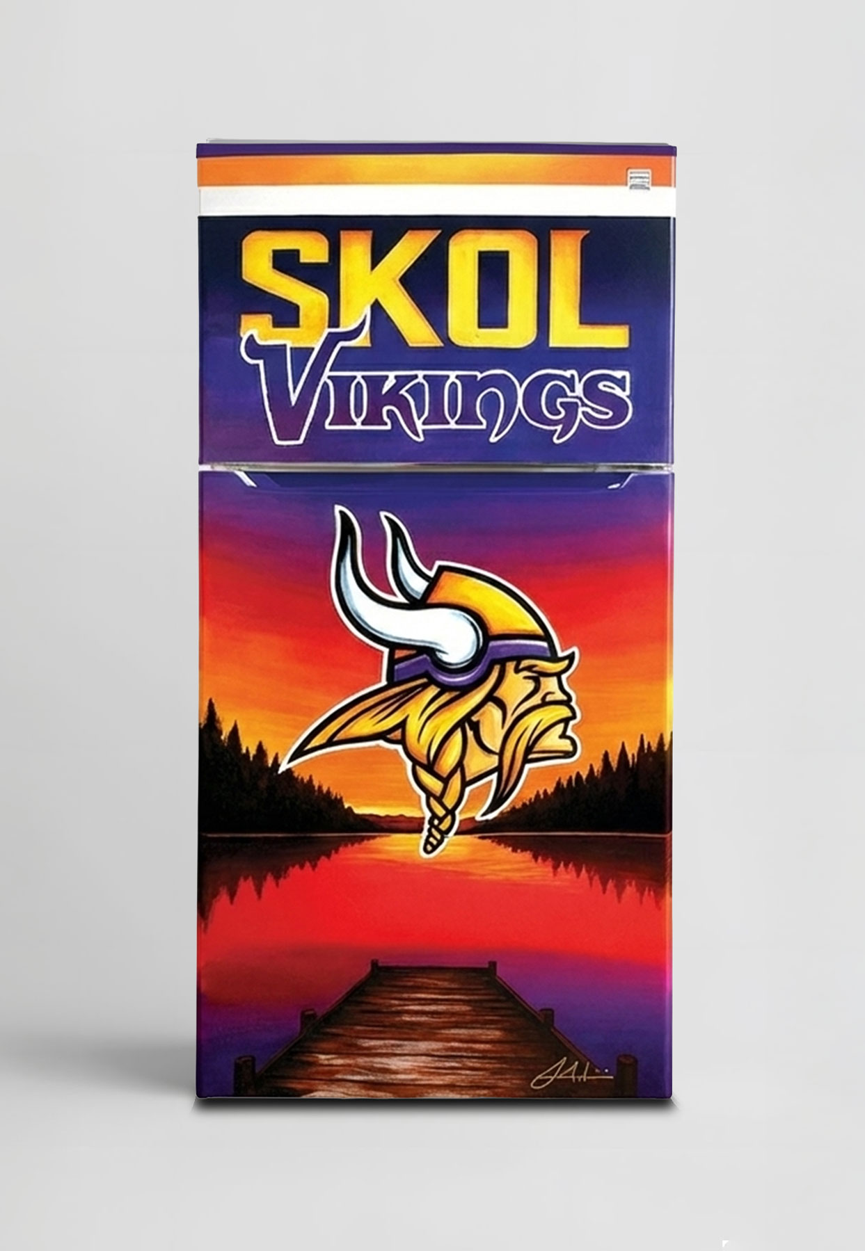 A vertical studio shot of a custom Kenmore refrigerator featuring Minnesota Vikings artwork against a plain white background. The freezer door displays 'SKOL Vikings' in large yellow and purple lettering. The main refrigerator door showcases a vibrant painting of a sunset over a lake with pine trees and a wooden dock, prominently featuring the Vikings Norseman logo in the center.